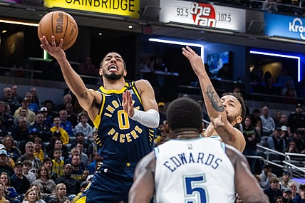 Mar 7, 2024; Indianapolis, Indiana, USA; Indiana Pacers guard Tyrese Haliburton (0) shoots the ball while Minnesota Timberwolves forward Kyle Anderson (1) defends during the second half at Gainbridge Fieldhouse. Mandatory Credit: Trevor Ruszkowski-USA TODAY Sports