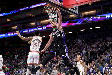 Mar 7, 2024; Sacramento, California, USA; Sacramento Kings forward Domantas Sabonis (10) dunks the ball in front of San Antonio Spurs forward Julian Champagnie (30) in the second quarter at the Golden 1 Center. Mandatory Credit: Cary Edmondson-USA TODAY Sports
