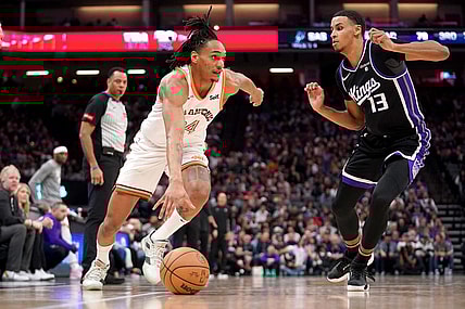Mar 7, 2024; Sacramento, California, USA; San Antonio Spurs guard Devin Vassell (24) dribbles past Sacramento Kings forward Keegan Murray (13) in the third quarter at the Golden 1 Center. Mandatory Credit: Cary Edmondson-USA TODAY Sports