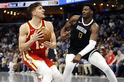 Mar 8, 2024; Memphis, Tennessee, USA; Atlanta Hawks guard Bogdan Bogdanovic (13) drives to the basket as Memphis Grizzlies forward-center Jaren Jackson Jr. (13) defends during the first half at FedExForum. Mandatory Credit: Petre Thomas-USA TODAY Sports