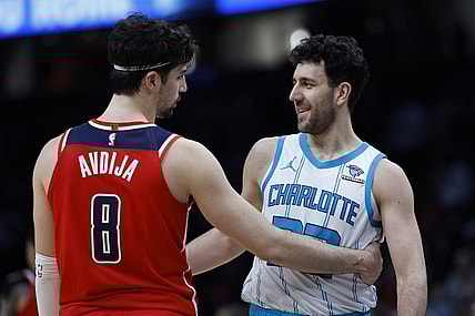 Mar 8, 2024; Washington, District of Columbia, USA; Washington Wizards forward Deni Avdija (8) hugs Charlotte Hornets guard Vasa Micic (22) after their game at Capital One Arena. Mandatory Credit: Geoff Burke-USA TODAY Sports
