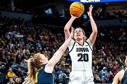 Iowa guard Kate Martin (20) attempts a shot against Michigan guard Lauren Hansen (1) during the Big Ten Tournament semifinals at the Target Center on Saturday, March 9, 2024, in Minneapolis, Minn.