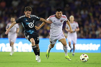 Mar 9, 2024; Orlando, Florida, USA; Orlando City midfielder Cesar Araujo (5) battles for the ball with Minnesota United midfielder Wil Trapp (20) during the first half at Inter & Co Stadium. Mandatory Credit: Nathan Ray Seebeck-USA TODAY Sports