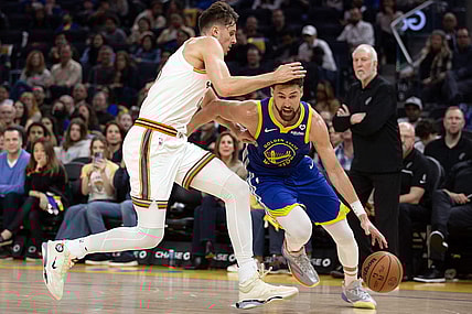 Mar 9, 2024; San Francisco, California, USA; Golden State Warriors guard Klay Thompson (11) drives around San Antonio Spurs forward Zach Collins (23) during the second quarter at Chase Center. Mandatory Credit: D. Ross Cameron-USA TODAY Sports