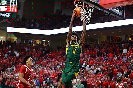 Mar 9, 2024; Lubbock, Texas, USA;  Baylor Bears forward Jalen Bridges (11) dunks the ball against Texas Tech Red Raiders guard Darrion Williams (5) in the second half at United Supermarkets Arena. Mandatory Credit: Michael C. Johnson-USA TODAY Sports