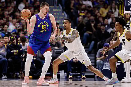 Mar 9, 2024; Denver, Colorado, USA; Denver Nuggets center Nikola Jokic (15) looks to pass the ball as Utah Jazz forward John Collins (20) guards in the second quarter at Ball Arena. Mandatory Credit: Isaiah J. Downing-USA TODAY Sports