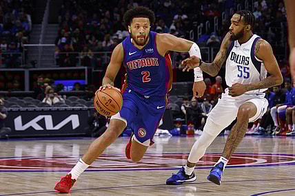 Mar 9, 2024; Detroit, Michigan, USA;  Detroit Pistons guard Cade Cunningham (2) dribbles defended by Dallas Mavericks forward Derrick Jones Jr. (55) in the second half at Little Caesars Arena. Mandatory Credit: Rick Osentoski-USA TODAY Sports