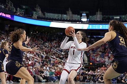 Mar 10, 2024; Greensboro, NC, USA; NC State Wolfpack center River Baldwin (1) shoots the ball over a defender in the first half against the Notre Dame Fighting Irish at Greensboro Coliseum. Mandatory Credit: David Yeazell-USA TODAY Sports