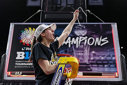 Mar 10, 2024; Minneapolis, MN, USA; Iowa Hawkeyes guard Caitlin Clark (22) cuts a piece off the net after the game against the Nebraska Cornhuskers at Target Center. Mandatory Credit: Matt Krohn-USA TODAY Sports