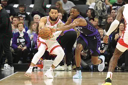 Mar 10, 2024; Sacramento, California, USA; Sacramento Kings guard De'Aaron Fox (right) reaches for a pass to Houston Rockets guard Fred VanVleet (left) during the first quarter at Golden 1 Center. Mandatory Credit: Darren Yamashita-USA TODAY Sports