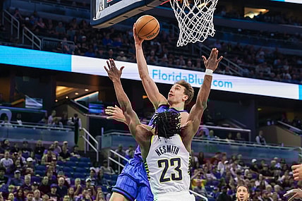Mar 10, 2024; Orlando, Florida, USA; Orlando Magic forward Franz Wagner (22) goes to the basket against Indiana Pacers forward Aaron Nesmith (23) during the first quarter at KIA Center. Mandatory Credit: Mike Watters-USA TODAY Sports