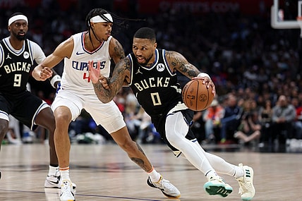Mar 10, 2024; Los Angeles, California, USA;  Milwaukee Bucks guard Damian Lillard (0) drives to the basket against Los Angeles Clippers guard Brandon Boston Jr. (4) during the third quarter at Crypto.com Arena. Mandatory Credit: Kiyoshi Mio-USA TODAY Sports