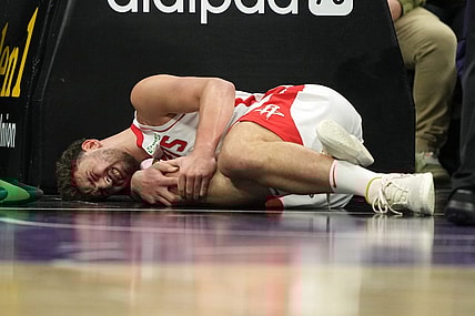 Mar 10, 2024; Sacramento, California, USA; Houston Rockets center Alperen Sengun (28) lies on the court after suffering an injury against the Sacramento Kings during the fourth quarter at Golden 1 Center. Mandatory Credit: Darren Yamashita-USA TODAY Sports