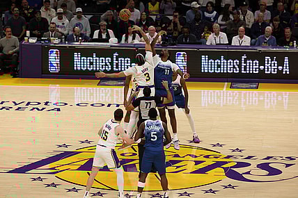 Mar 10, 2024; Los Angeles, California, USA;  Los Angeles Lakers forward Anthony Davis (3) and Minnesota Timberwolves center Naz Reid (11) tip off during the first quarter at Crypto.com Arena. Mandatory Credit: Kiyoshi Mio-USA TODAY Sports