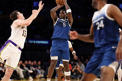Mar 10, 2024; Los Angeles, California, USA;  Minnesota Timberwolves guard Anthony Edwards (5) shoots the ball over Los Angeles Lakers guard Austin Reaves (15) during the fourth quarter at Crypto.com Arena. Mandatory Credit: Kiyoshi Mio-USA TODAY Sports