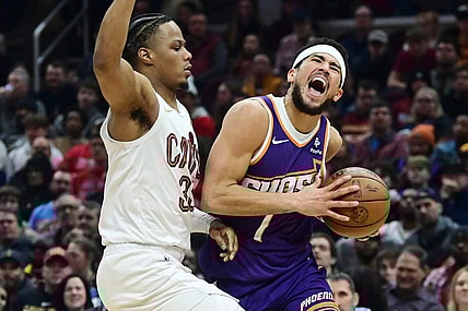 Mar 11, 2024; Cleveland, Ohio, USA; Phoenix Suns guard Devin Booker (1) drives to the basket against Cleveland Cavaliers forward Isaac Okoro (35) during the first half at Rocket Mortgage FieldHouse. Mandatory Credit: Ken Blaze-USA TODAY Sports
