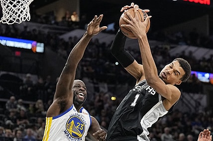 Mar 11, 2024; San Antonio, Texas, USA; San Antonio Spurs forward Victor Wembanyama (1) grabs a rebound away from Golden State Warriors forward Draymond Green (23) during the first half at Frost Bank Center. Mandatory Credit: Scott Wachter-USA TODAY Sports