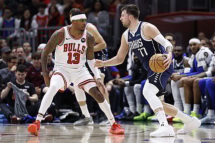 Mar 11, 2024; Chicago, Illinois, USA; Dallas Mavericks guard Luka Doncic (77) drives to the basket against Chicago Bulls forward Torrey Craig (13) during the first half at United Center. Mandatory Credit: Kamil Krzaczynski-USA TODAY Sports