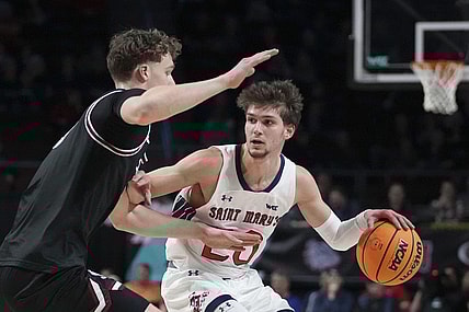 March 11, 2024; Las Vegas, NV, USA; Saint Mary's Gaels guard Aidan Mahaney (20) dribbles the basketball against Santa Clara Broncos center Christoph Tilly (13) during the first half in the semifinals of the WCC Basketball Championship at Orleans Arena. Mandatory Credit: Kyle Terada-USA TODAY Sports