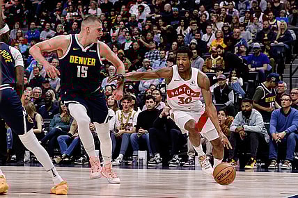 Mar 11, 2024; Denver, Colorado, USA; Toronto Raptors guard Ochai Agbaji (30) drives to the basket against Denver Nuggets center Nikola Jokic (15) in the second quarter at Ball Arena. Mandatory Credit: Isaiah J. Downing-USA TODAY Sports