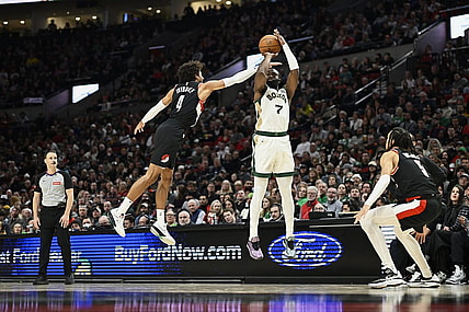 Mar 11, 2024; Portland, Oregon, USA; Boston Celtics guard Jaylen Brown (7) shoots a three point jump shot during the first half against Portland Trail Blazers guard Matisse Thybulle (4) and guard Dalano Banton (5) at Moda Center. Mandatory Credit: Troy Wayrynen-USA TODAY Sports