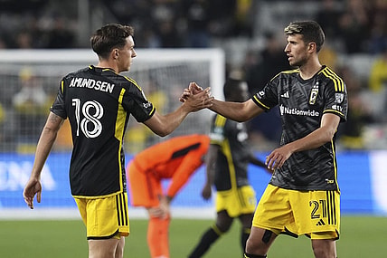 Mar 12, 2024; Columbus, OH, USA;  Columbus Crew defender Malte Amundsen (18) celebrates the win with defender Yevhen Cheberko (21) following the Concacaf Champions Cup soccer game against the Houston Dynamo at Lower.com Field. Mandatory Credit: Adam Cairns-USA TODAY Sports