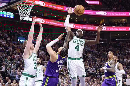 Mar 12, 2024; Salt Lake City, Utah, USA; Utah Jazz guard Keyonte George (3) drives into Boston Celtics forward Sam Hauser (30) and has the shot blocked by guard Jrue Holiday (4) during the fourth quarter at Delta Center. Mandatory Credit: Rob Gray-USA TODAY Sports