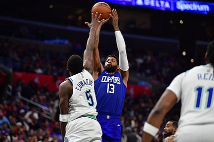 Mar 12, 2024; Los Angeles, California, USA; Los Angeles Clippers forward Paul George (13) shoots against Minnesota Timberwolves guard Anthony Edwards (5) during the second half at Crypto.com Arena. Mandatory Credit: Gary A. Vasquez-USA TODAY Sports