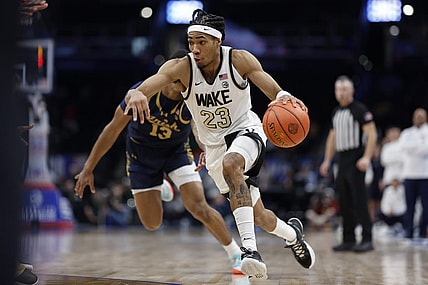 Mar 13, 2024; Washington, D.C., USA; Wake Forest Demon Deacons guard Hunter Sallis (23) drives to the basket past Notre Dame Fighting Irish forward Tae Davis (13) in the second half at Capital One Arena. Mandatory Credit: Geoff Burke-USA TODAY Sports