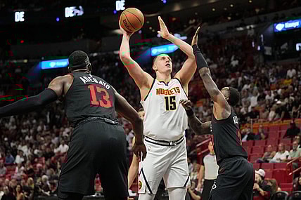 Mar 13, 2024; Miami, Florida, USA;  Denver Nuggets center Nikola Jokic (15) takes a shot over Miami Heat guard Terry Rozier (2) during the first half at Kaseya Center. Mandatory Credit: Jim Rassol-USA TODAY Sports