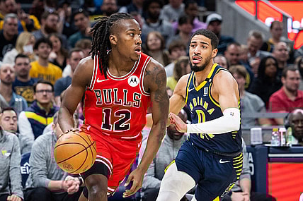 Mar 13, 2024; Indianapolis, Indiana, USA; Chicago Bulls guard Ayo Dosunmu (12) dribbles the ball while Indiana Pacers guard Tyrese Haliburton (0) defends in the first half at Gainbridge Fieldhouse. Mandatory Credit: Trevor Ruszkowski-USA TODAY Sports