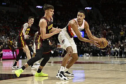 Mar 13, 2024; Portland, Oregon, USA; Portland Trail Blazers forward Kris Murray (8) looks for an opening during the first half against Atlanta Hawks guard Bogdan Bogdanovic (13) at Moda Center. Mandatory Credit: Troy Wayrynen-USA TODAY Sports