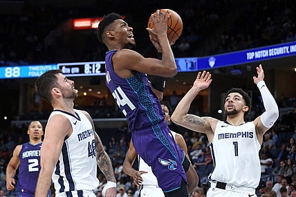 Mar 12, 2024; Memphis, Tennessee, USA; Charlotte Hornets forward Brandon Miller (24) drives to the basket between Memphis Grizzlies guard John Konchar (46) and guard Scotty Pippen Jr. (1)  during the second half at FedExForum. Mandatory Credit: Petre Thomas-USA TODAY Sports