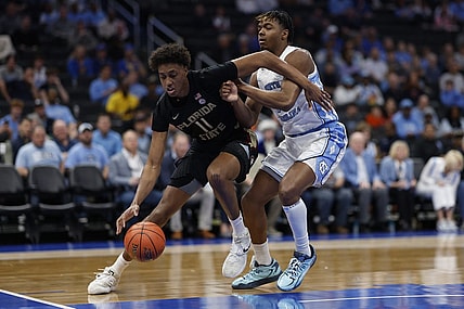Mar 14, 2024; Washington, D.C., USA; Florida State forward Baba Miller (11) drives to the basket as North Carolina forward Harrison Ingram (55) defends in the first half at Capital One Arena. Mandatory Credit: Geoff Burke-USA TODAY Sports
