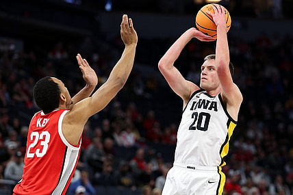 Mar 14, 2024; Minneapolis, MN, USA; Iowa Hawkeyes forward Payton Sandfort (20) shoots as Ohio State Buckeyes forward Zed Key (23) defends during the first half at Target Center. Mandatory Credit: Matt Krohn-USA TODAY Sports