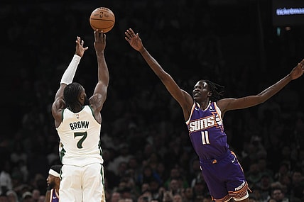 Mar 14, 2024; Boston, Massachusetts, USA;  Boston Celtics guard Jaylen Brown (7) shoots the ball over Phoenix Suns center Bol Bol (11) during the first half at TD Garden. Mandatory Credit: Bob DeChiara-USA TODAY Sports