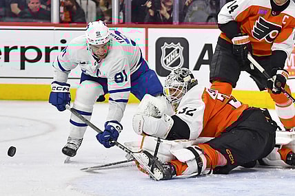 Mar 14, 2024; Philadelphia, Pennsylvania, USA; Philadelphia Flyers goaltender Felix Sandstrom (32) makes a save against Toronto Maple Leafs center John Tavares (91) during the second period at Wells Fargo Center. Mandatory Credit: Eric Hartline-USA TODAY Sports