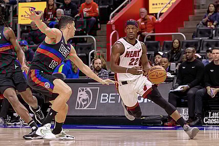 Mar 15, 2024; Detroit, Michigan, USA; Miami Heat forward Jimmy Butler (22) drives to the basket as Detroit Pistons forward Simone Fontecchio (19) defends during the first quarter at Little Caesars Arena. Mandatory Credit: David Reginek-USA TODAY Sports