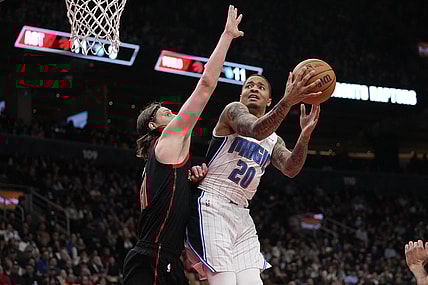 Mar 15, 2024; Toronto, Ontario, CAN; Toronto Raptors forward Kelly Olynyk (41) defends against Orlando Magic guard Markelle Fultz (20) during the first half at Scotiabank Arena. Mandatory Credit: John E. Sokolowski-USA TODAY Sports