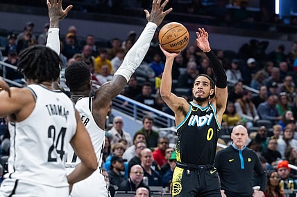 Mar 16, 2024; Indianapolis, Indiana, USA; Indiana Pacers guard Tyrese Haliburton (0) shoots the ball while Brooklyn Nets guard Dennis Schroder (17) defends in the first half at Gainbridge Fieldhouse. Mandatory Credit: Trevor Ruszkowski-USA TODAY Sports
