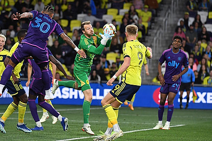 Mar 16, 2024; Nashville, Tennessee, USA; Nashville SC goalkeeper Joe Willis (1) catches the ball on a corner kick during the second half against Charlotte FC at Geodis Park. Mandatory Credit: Christopher Hanewinckel-USA TODAY Sports