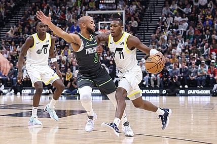 Mar 16, 2024; Salt Lake City, Utah, USA; Utah Jazz guard Kris Dunn (11) drives against Minnesota Timberwolves guard Jordan McLaughlin (6) during the second quarter at Delta Center. Mandatory Credit: Rob Gray-USA TODAY Sports