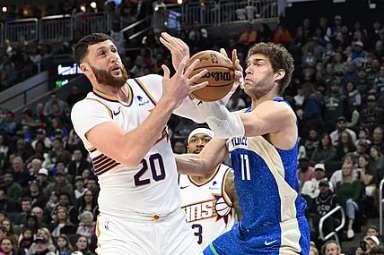 Mar 17, 2024; Milwaukee, Wisconsin, USA; Phoenix Suns center Jusuf Nurkic (20) and Milwaukee Bucks center Brook Lopez (11) battle for possession of the ball in the first half at Fiserv Forum. Mandatory Credit: Michael McLoone-USA TODAY Sports