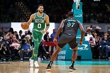 Mar 17, 2024; Washington, District of Columbia, USA; Boston Celtics forward Jayson Tatum (0) brings the ball up court against Washington Wizards forward Eugene Omoruyi (97) during the first half of the game at Capital One Arena. Mandatory Credit: Scott Taetsch-USA TODAY Sports