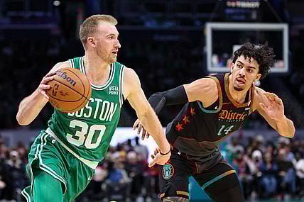 Mar 17, 2024; Washington, District of Columbia, USA; Boston Celtics forward Sam Hauser (30) drives to the basket against Washington Wizards guard Jules Bernard (14) during the first half of the game at Capital One Arena. Mandatory Credit: Scott Taetsch-USA TODAY Sports