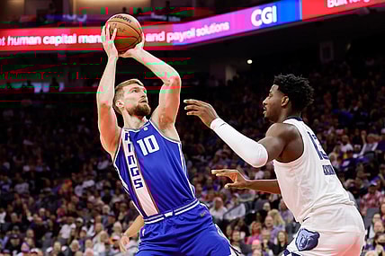 Mar 18, 2024; Sacramento, California, USA; Sacramento Kings forward Domantas Sabonis (10) shoots the ball against Memphis Grizzlies forward Jaren Jackson Jr. (13) during the first quarter at Golden 1 Center. Mandatory Credit: Sergio Estrada-USA TODAY Sports