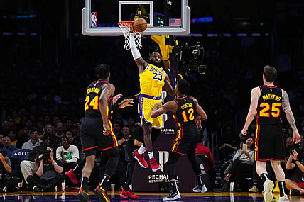 Mar 18, 2024; Los Angeles, California, USA; Los Angeles Lakers forward LeBron James (23) reaches for the ball against Atlanta Hawks forward Bruno Fernando (24), Atlanta Hawks forward De'Andre Hunter (12) and guard Garrison Mathews (25) in the first half at Crypto.com Arena. Mandatory Credit: Kirby Lee-USA TODAY Sports