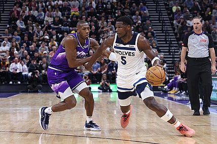 Mar 18, 2024; Salt Lake City, Utah, USA; Minnesota Timberwolves guard Anthony Edwards (5) drives against Utah Jazz guard Kris Dunn (11) during the third quarter at Delta Center. Mandatory Credit: Rob Gray-USA TODAY Sports