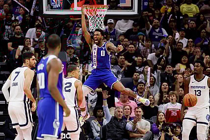 Mar 18, 2024; Sacramento, California, USA; Sacramento Kings guard Malik Monk (0) dunks the ball during the fourth quarter against the Memphis Grizzlies at Golden 1 Center. Mandatory Credit: Sergio Estrada-USA TODAY Sports