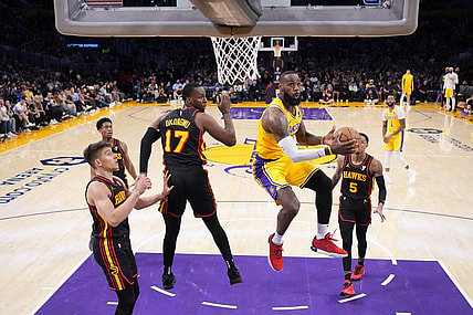 Mar 18, 2024; Los Angeles, California, USA; Los Angeles Lakers forward LeBron James (23) shoots the ball against Atlanta Hawks forward Onyeka Okongwu (17) in the second half at Crypto.com Arena. Mandatory Credit: Kirby Lee-USA TODAY Sports